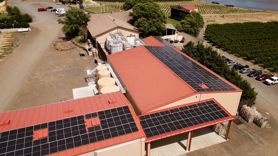 Maryhill Winery added a rooftop solar array to the Columbia Gorge landscape, which is dotted with windmills. The region&rsquo;s drier, sunnier weather is excellent for growing grapes and producing solar power, winery owner Craig Leuthold said. (Contributed by Maryhill Winery)