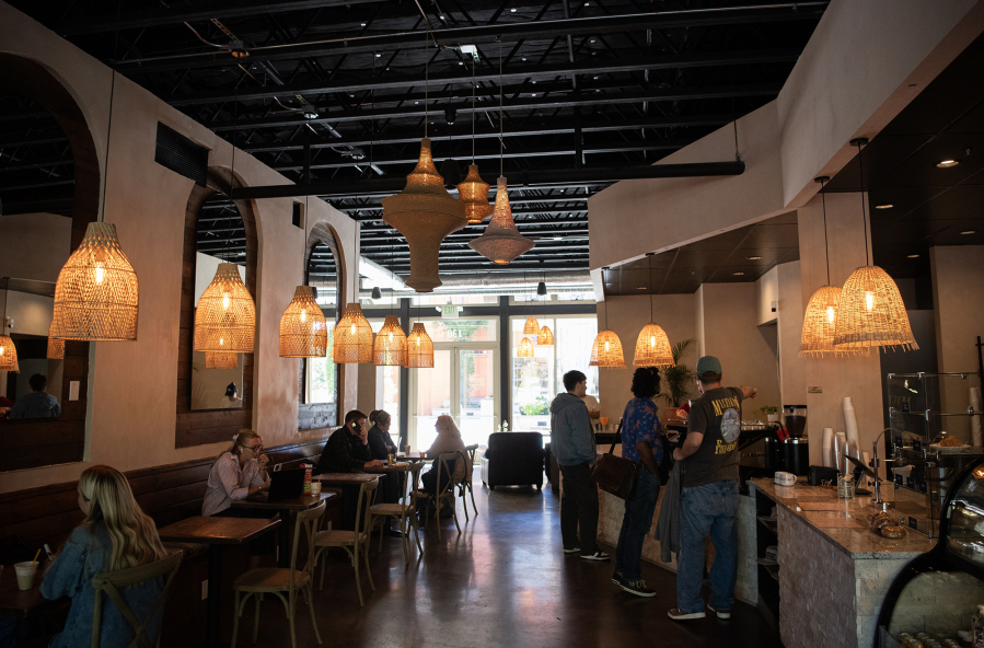 Customers fill Compass Coffee Roasting on Monday in Washougal. (Taylor Balkom/The Columbian)