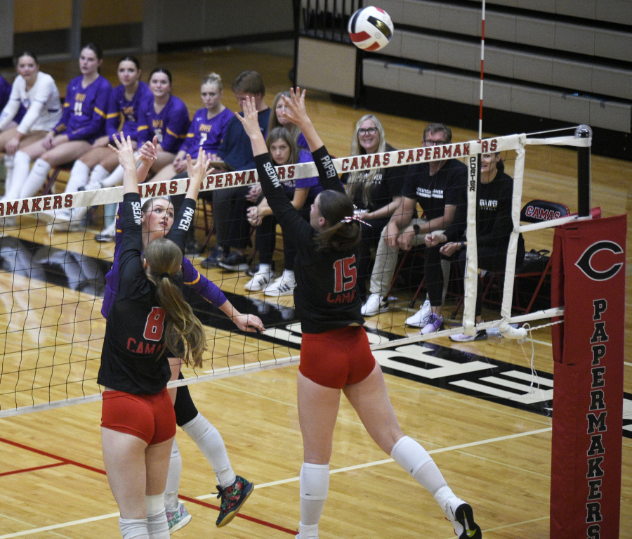 Columbia River junior Chiara Cooper, center, hits the ball past Camas blockers Kendyl Wiest (8) and Quinn Pedersen (15) during a non-league volleyball match on Monday, Sept. 22, 2025 at Camas High School. (Micah Rice/The Columbian)