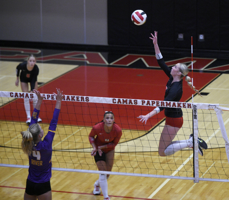 Camas senior Ella Thompson, right, leaps toward the ball during a non-league volleyball match against Columbia River on Monday, Sept. 22, 2025 at Camas High School. (Micah Rice/The Columbian)