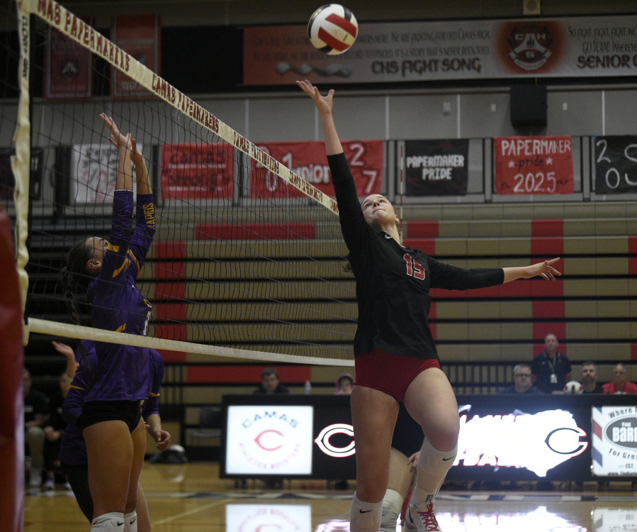 Camas senior Quinn Pederson, right, leaps toward the ball during a non-league volleyball match against Columbia River on Monday, Sept. 22, 2025 at Camas High School. (Micah Rice/The Columbian)