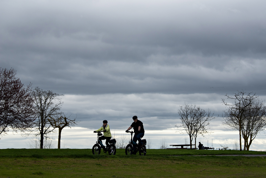 Cyclists cruise along a bike path at Frenchman’s Bar Regional Park on May 24. Higher parking fees will take effect Jan. 1. (Amanda Cowan/The Columbian files)