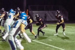 Camas running back Thor Brody, middle, looks for a hole against Coeur d&rsquo;Alene during the non-league game Friday at Doc Harris Stadium. (Jeff Klein/The Columbian)
