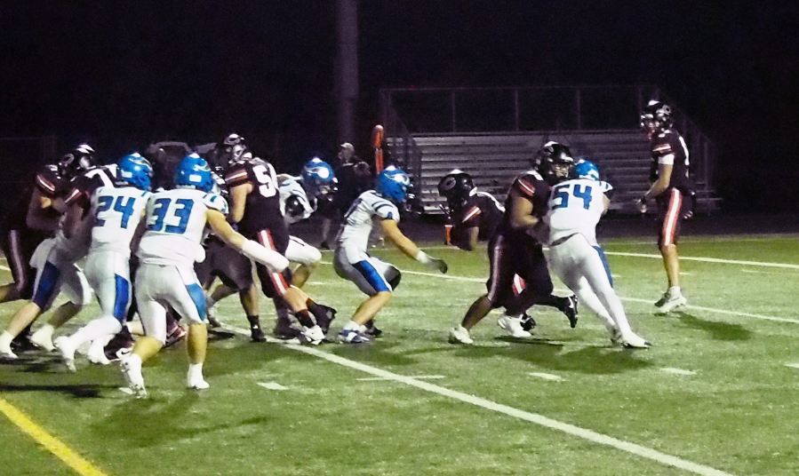 Camas running back Thor Brody, middle, looks for a hole against Coeur d'Alene during the non-league game Friday, Oct. 3, 2025 at Doc Harris Stadium. (Jeff Klein/The Columbian)