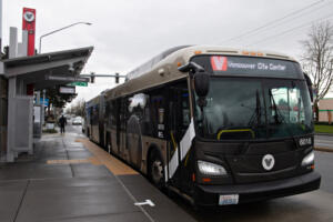 A red C-Tran Vine bus departs the stop at the intersection of Southeast Heartwood Boulevard and Southeast Mill Plain Boulevard on Feb. 25. (Amanda Cowan/The Columbian files)