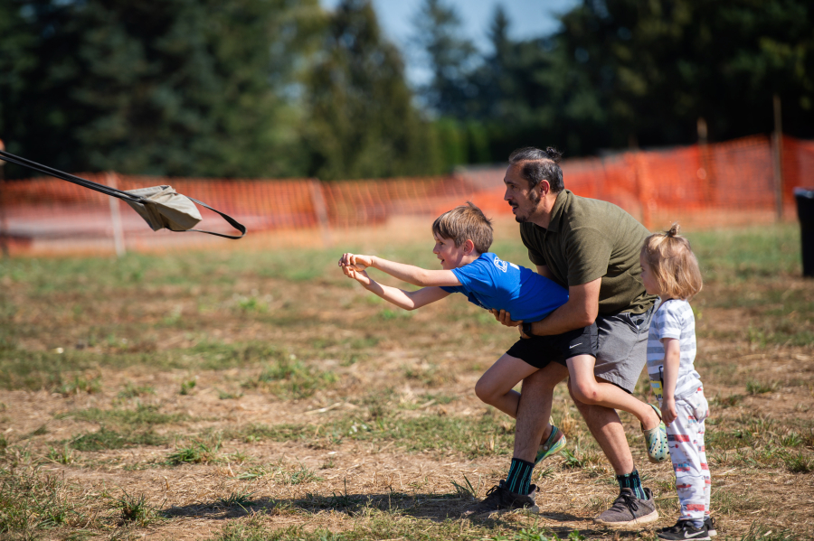 Timor Holove and his sons Isaac, 8, and Ezra, 2, try their hands at the pumpkin launcher at Bi-Zi Farms.