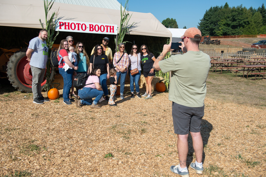 A family takes a portrait on opening day Sept. 20 at Brush Prairie&rsquo;s Bi-Zi Farms Pumpkin Patch. (Photos by James Rexroad for The Columbian)