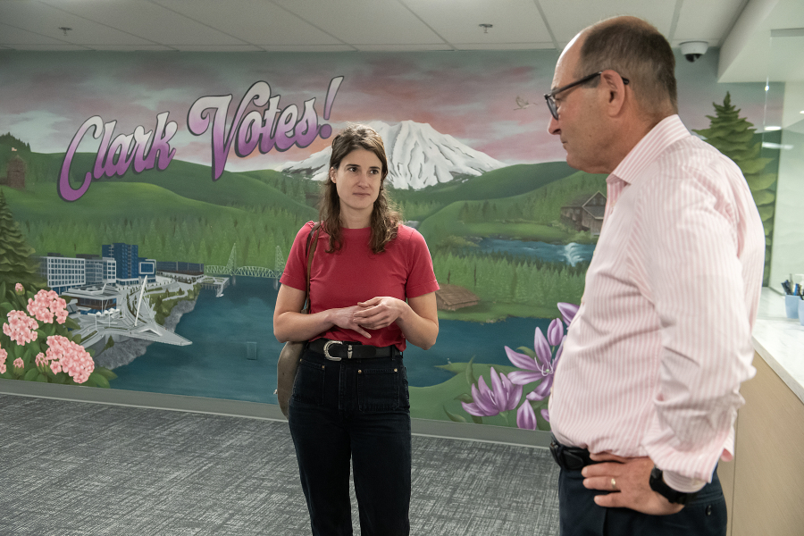 U.S. Rep. Marie Gluesenkamp Perez, D-Skamania, left, talks with Clark County Auditor Greg Kimsey at the elections office in downtown Vancouver on Wednesday afternoon. During their meeting, the pair discussed the Trump administration’s threat to end vote-by-mail election options. (Amanda Cowan/The Columbian)