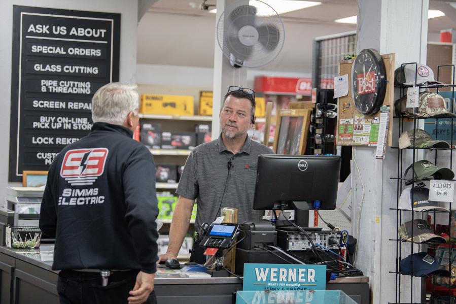Customer David Simms of Simms Electric, left, chats with Aaron Lutz of Lutz Hardware while stopping by the checkout stand in Camas on Monday afternoon. (Amanda Cowan/The Columbian)