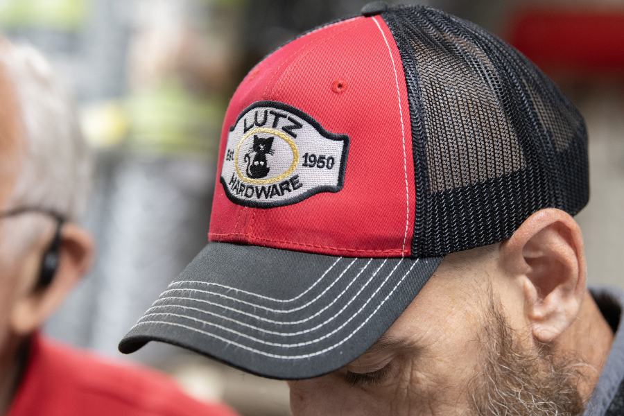 Zach Caine of Lutz Hardware in Camas wears a store hat with a kitty logo on Monday afternoon. The store has a resident cat. (Amanda Cowan/The Columbian)