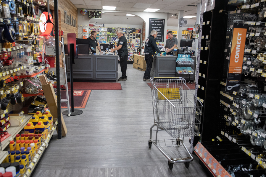 Customers make purchases at Lutz Hardware in Camas on Monday afternoon. (Amanda Cowan/The Columbian)
