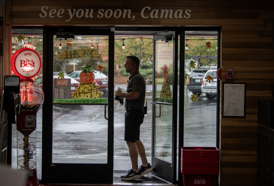 Aaron Lutz of Lutz Hardware walks out the store’s front door to run an errand in Camas on Monday afternoon. (Amanda Cowan/The Columbian)