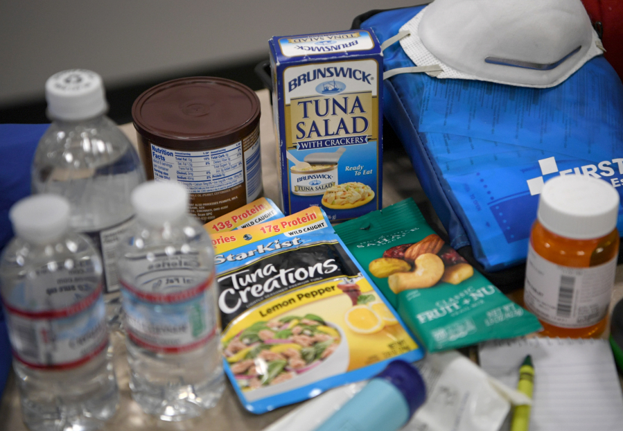 Emergency supplies typically found in “go bags” sit on a table  Tuesday at Clark Regional Emergency Services. (Taylor Balkom/The Columbian)