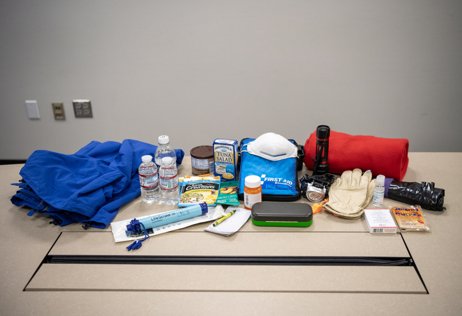Emergency supplies typically found in “go bags” sit on a table Tuesday at Clark Regional Emergency Services. (Taylor Balkom/The Columbian)
