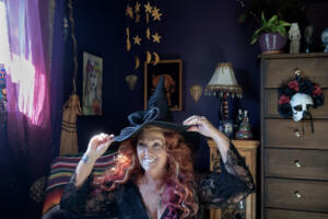 Angel Biederbeck, high priestess of the Columbia River Witches Collective, adjusts her hat at her Camas home on Oct. 14. The collective has 434 Facebook followers and a core coven of 13 witches. (Amanda Cowan/The Columbian)