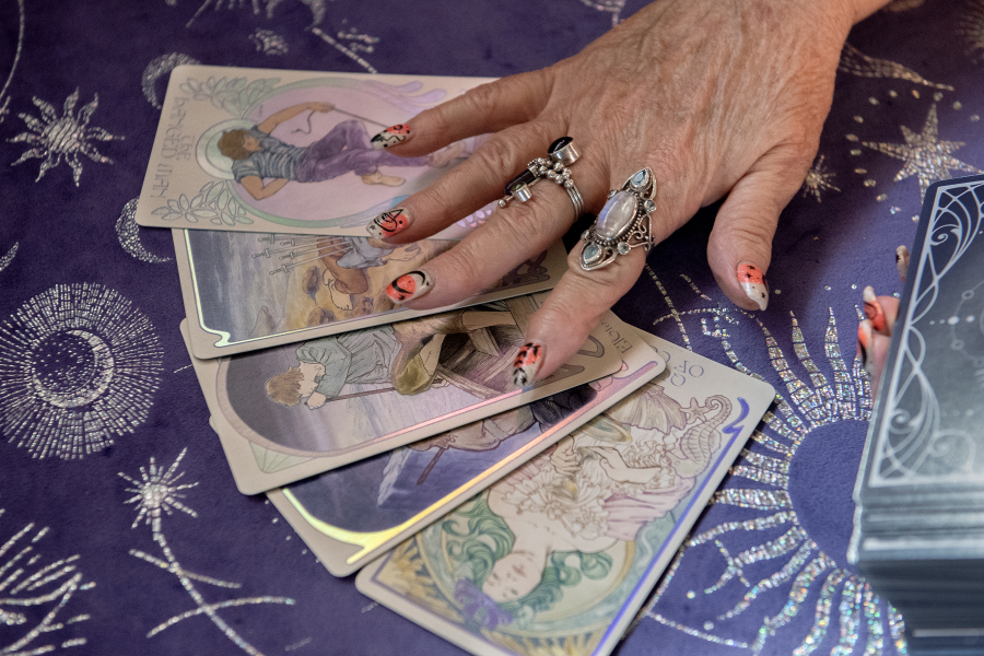 High Priestess Angel Biederbeck of the Columbia River Witches Collective lays out tarot cards at her home in Camas on Oct. 14. Private tarot readings and other forms of divination are part of her skills. (Amanda Cowan/The Columbian)