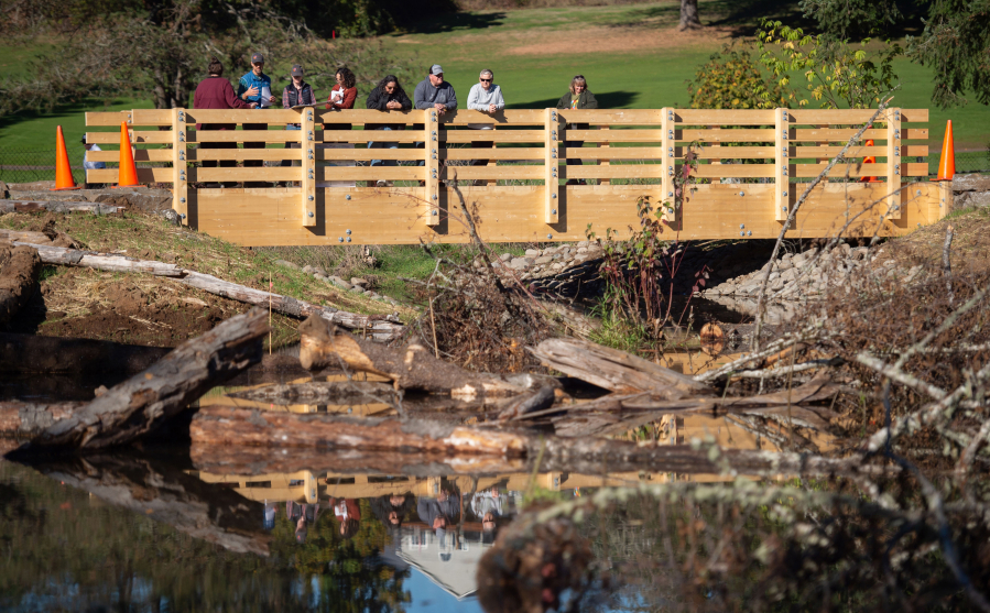 Corinthia Barnhart, program manager for Washougal’s parks and cemetery department, talks about the work done at Mable Kerr Park over the summer. Now open, the park was closed in August to allow the city and Lower Columbia Estuary Partnership to work on restoring floodplain areas along Campen Creek. A new bridge over a larger stream allows visitors to reach wilder areas of the park. (Photos by James Rexroad/for The Columbian)
