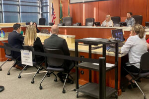 Doug Olson, left, from the FBI’s Portland field office, is joined by fellow agents Mari Panovich and Jason Newport as they address the Clark County Council during a work session Wednesday. (Shari Phiel/The Columbian)