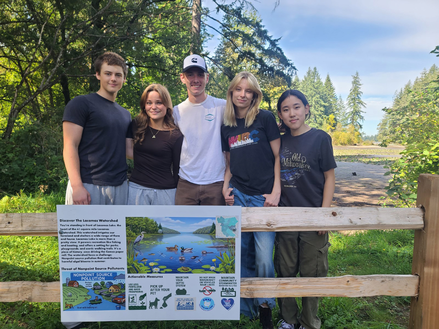 Camas High School students, from left to right, Colton Schaefer, Veronica Sparling, Austin Anderson, Dana Sparling and Audreen Tsai, members of the Camas High School Watershed Alliance Club, pose for a photo in front of one of their informational signs at Lacamas Lake in September. (Contributed by the city of Camas)
