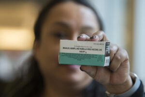 Registered nurse Diana Byrd holds a box containing the measles vaccine at the Kaiser Permanente Cascade Park office on Feb. 4, 2019. The last measles outbreak in Clark County was January to April 2019. (Amanda Cowan/The Columbian files)