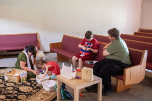 Robyn Kistemaker, from left, plays with daughter Noelle Hively, 5, while dad David Hively, right, watches son Lucas Hively, 11, play with a toy from the Pray-Ground area Sept. 8 at Messiah Lutheran Church. Both parents are pastors there.
“Living with folks who are autistic has its own challenges, and so sometimes Noelle ends up feeling like the oddball out, or I end up feeling like the oddball out,” David Hively said, “because these two are over here geeking out about sharks or rocks or something. And they’re just sharks, they’re just rocks, why are we so invested in this?” (Taylor Balkom/The Columbian)