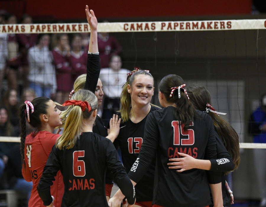 Shaylee Stephen, center, and her Camas teammates celebrate after a point during a non-league volleyball match against Prairie on Tuesday. (Micah Rice/The Columbian)