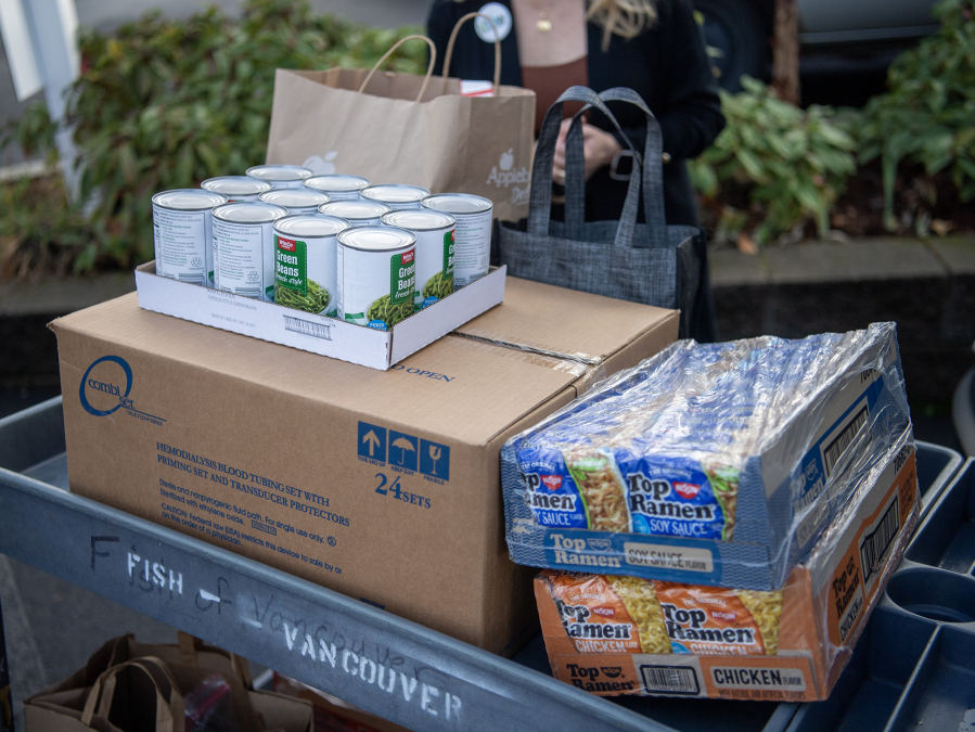 Donated food sits on a cart Tuesday at FISH of Vancouver. (Taylor Balkom/The Columbian)