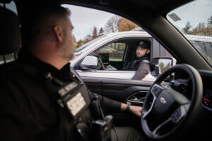 Sgt. Chris Nicholls of the Clark County Sheriff’s Office, left, pauses to talk with Deputy Holden Chapman while on patrol Nov. 7. Some agencies have seen a decline in applicants for open positions since the pandemic and are trying new strategies to recruit and retain officers. (Amanda Cowan/The Columbian)