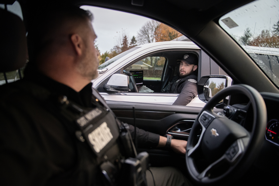 Sgt. Chris Nicholls of the Clark County Sheriff&rsquo;s Office, left, pauses to talk with Deputy Holden Chapman while on patrol Nov. 7. Some agencies have seen a decline in applicants for open positions since the pandemic and are trying new strategies to recruit and retain officers. (Amanda Cowan/The Columbian)