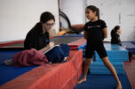 Instructor Bailey Morgan, left, takes notes on Camila Pina&rsquo;s tumbling skills Sunday during Camas Washougal Youth Cheer practice at VEGA Gymnastics in Washougal. (Taylor Balkom/The Columbian)