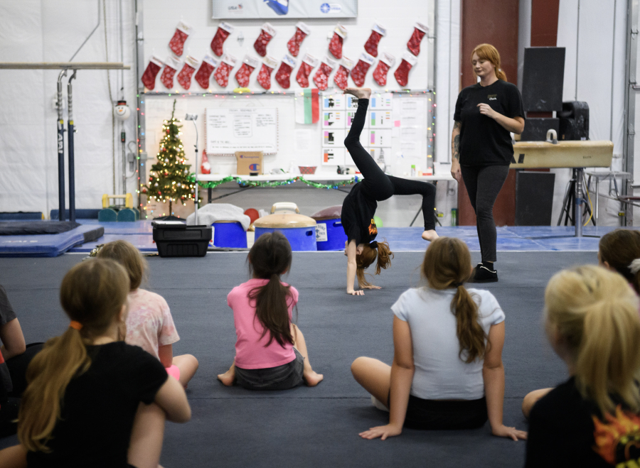 Camas Washougal Youth Cheer co-founder Crista Braun, right, has Liberty Braun, 9, demonstrate a tumble Sunday during practice at VEGA Gymnastics in Washougal. (Taylor Balkom/The Columbian)