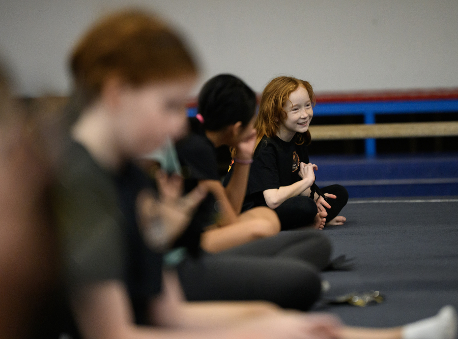 Liberty Braun, 9, answers a question Sunday during a Camas Washougal Youth Cheer practice at VEGA Gymnastics in Washougal. (Taylor Balkom/The Columbian)