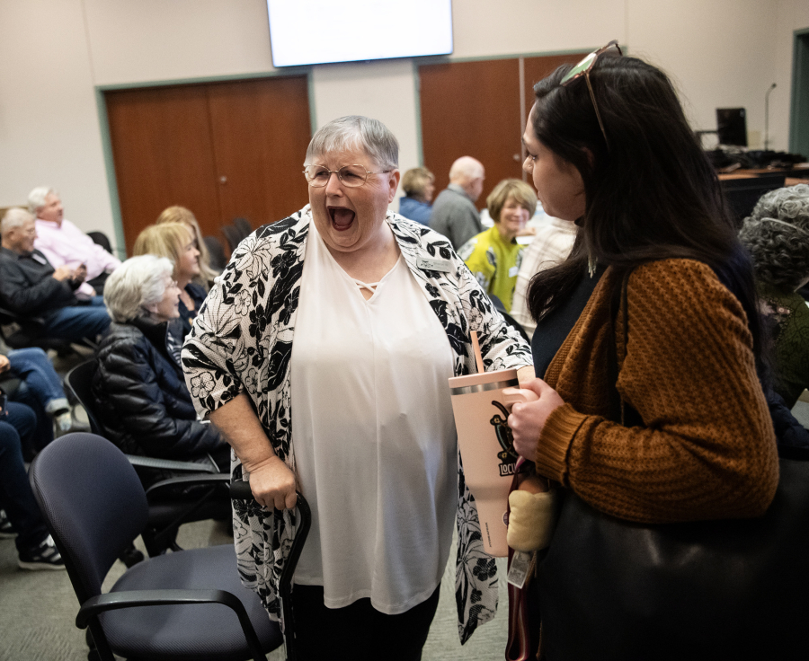 Sharon Wodtke, center, laughs with Holly Hill, right, on Wednesday during a Clark County Commission on Aging meeting at the Clark County Public Service Center. Wodtke, a Battle Ground resident, received the commission&rsquo;s sixth annual Silver Citizen Award. Hill nominated Wodtke for the award. (Taylor Balkom/The Columbian)