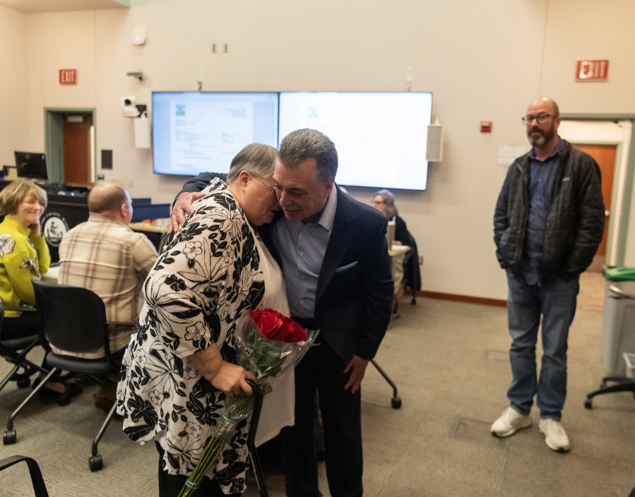 Sharon Wodtke, left, hugs Battle Ground Police Chief Dennis Flynn on Wednesday during a Clark County Commission on Aging meeting at the Clark County Public Service Center. Wodtke, a Battle Ground resident, received the commission&rsquo;s Silver Citizen Award.