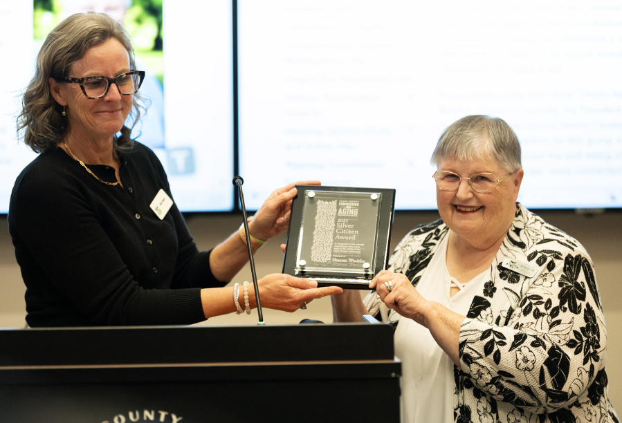 Sharon Wodtke, right, poses with her Silver Citizen Award and Clark County Commission on Aging member Ellen Rogers on Wednesday during a Clark County Commission on Aging meeting at the Clark County Public Service Center. (Taylor Balkom/The Columbian)