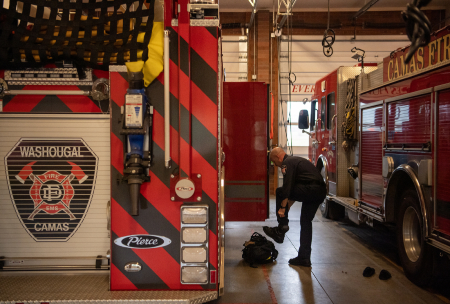 Camas-Washougal Fire Department Capt. James Tierney gears up at Fire Station 42 in Camas. The cities have run a joint fire department for 12 years, but leaders would rather create a regional fire authority. (Taylor Balkom/The Columbian files)