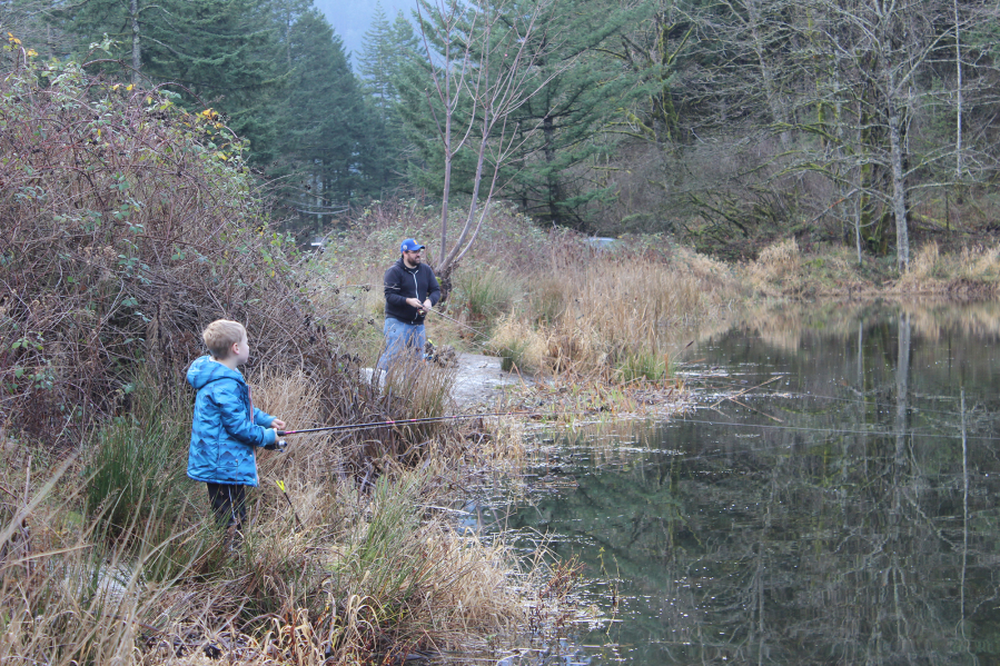 A father and son team try their luck in Icehouse Lake. It was stocked recently with 2,000 rainbow trout and is fishing well. (Terry Otto for The Columbian)