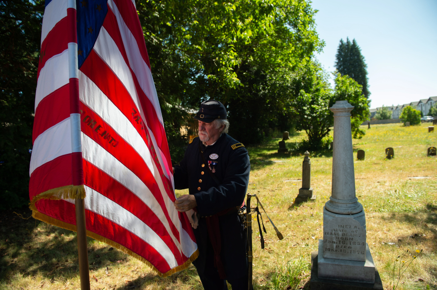Marks Stevens folds a California 71st Regiment flag during a 2024 ceremony honoring a Civil War veteran named Blandaman Smith with a new headstone at Brush Prairie Cemetery. (The Columbian files)
