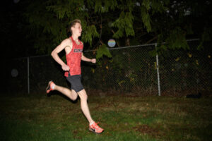 Camas cross country runner Cohen Butler runs near a treeline Thursday, Nov. 13, 2025, at Camas High School. Butler is The ColumbianÇƒÙs All-Region boys cross country runner of the year. (Taylor Balkom/The Columbian)