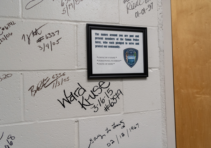 Signatures of police officers adorn the wall of the armory at the Camas Police Department headquarters. (Taylor Balkom/The Columbian)