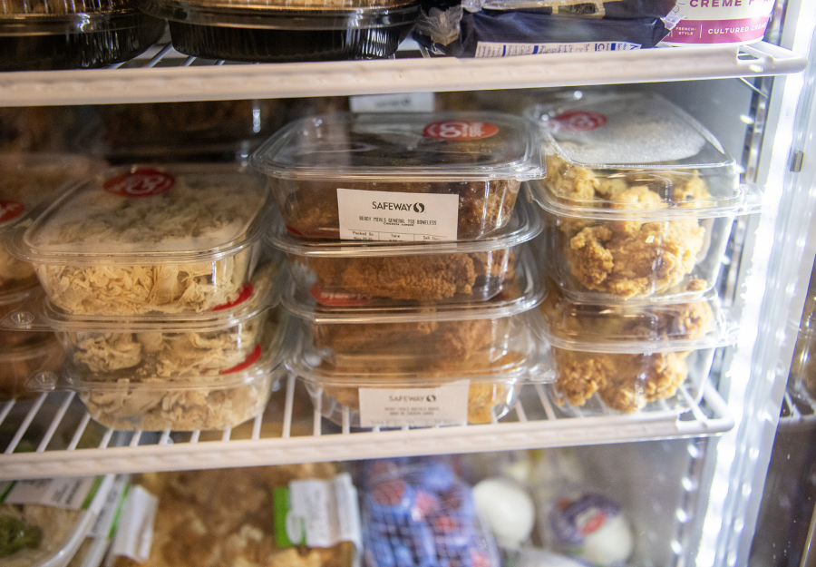 Prepared foods donated by Safeway sit in a cooler at Martha&rsquo;s Pantry. (Taylor Balkom/The Columbian)