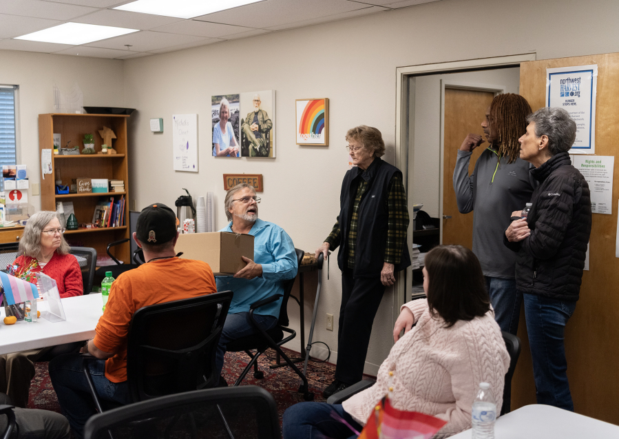 Volunteers meet before clients start showing up at Martha&rsquo;s Pantry on a recent Tuesday morning. Martha&rsquo;s Pantry is entirely volunteer run, Vicki Smith said, and nobody gets paid. (Taylor Balkom/The Columbian)