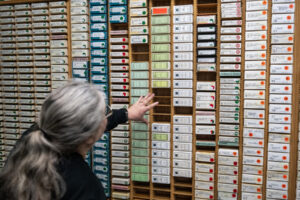 Clark County Genealogical Society President Paula Schoenlein looks over recently donated microfilm Friday at the Clark County Genealogical Society. The Camas Public Library recently donated its historical newspaper microfilm collection to the organization. (Taylor Balkom/The Columbian)
