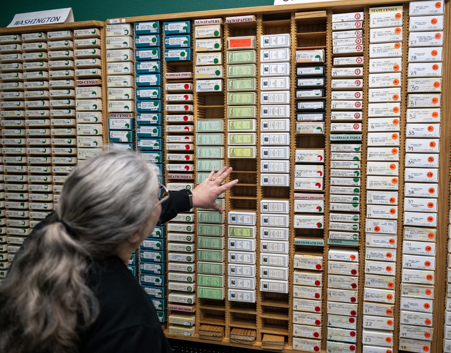 Clark County Genealogical Society President Paula Schoenlein looks over recently donated microfilm Friday at the Clark County Genealogical Society. The Camas Public Library recently donated its historical newspaper microfilm collection to the organization. (Taylor Balkom/The Columbian)