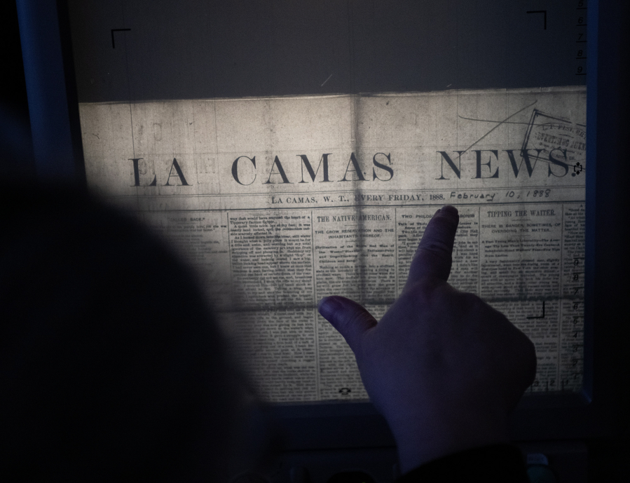 Clark County Genealogical Society President Paula Schoenlein reads over the Feb. 10, 1888, edition of Lacamas News.