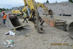 A photo taken a day after the June incident on a Rotschy jobsite shows the excavator bucket that came unlatched from the excavator arm quick coupler, falling onto a worker twice. (Contributed by the Washington State Department of Labor & Industries)