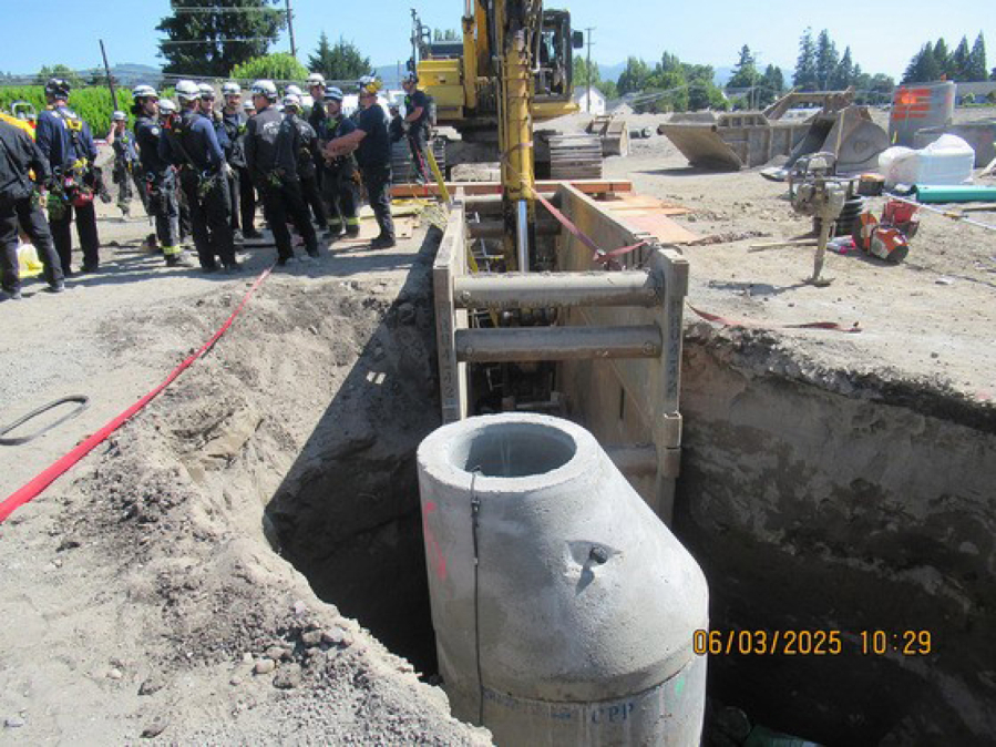 An upright sewer manhole, shown here in a Washington State Department of Labor & Industries photo from the Rotschy jobsite, has no walkway across the 10-foot-deep trench. Employees and the supervisor jumped over the trench to get across, according to the department. (Contributed by the Washington State Department of Labor & Industries)