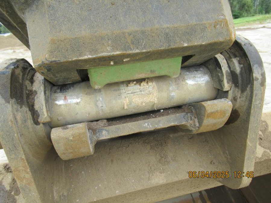 A Washington State Department of Labor & Industries photo shows the green safety latch that was missing from the excavator bucket that fell onto a Rotschy employee in June. (Contributed by the Washington State Department of Labor & Industries)