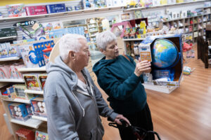 Shoppers Lyle, left, and Diana Smith look at a globe as a potential gift Thursday at Kazoodles Toys & Gifts in east Vancouver. (Photos by Taylor Balkom/The Columbian)