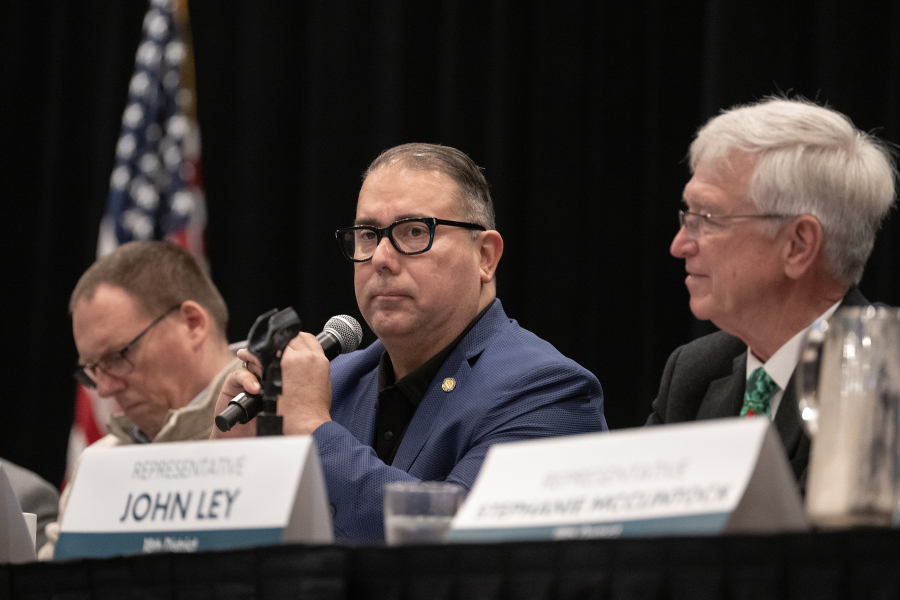 Rep. Kevin Waters, from left, listens as Sen. Adrian Cortes speaks as Rep. John Ley looks on during Greater Vancouver Chamber Legislative Outlook event at the Hilton Vancouver on Tuesday morning. (amanda cowan/The Columbian)